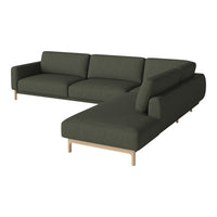 Dark green fabric sectional sofa with a minimalist design and light wood legs, ideal for modern interiors.