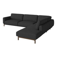 Modern dark gray sectional sofa with a sleek design and textured fabric pattern, complemented by wood legs.