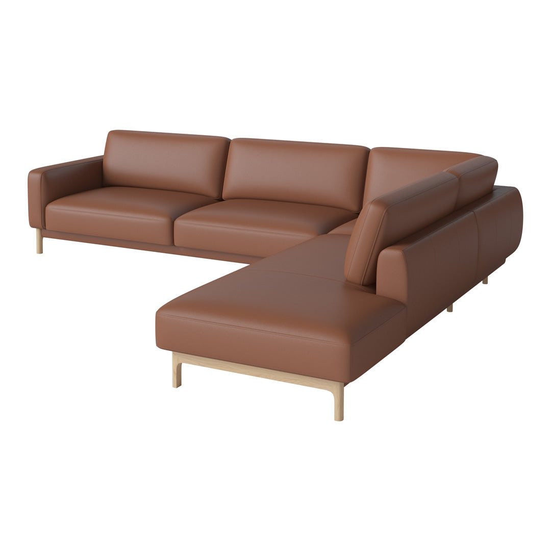 Brown leather sectional sofa with smooth texture and minimalist design, featuring a light wooden base.