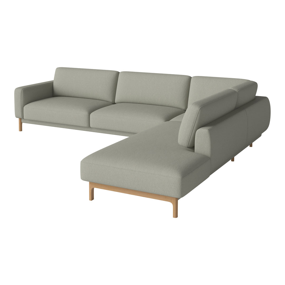 Light gray sectional sofa with clean lines and a minimalist design, featuring a soft fabric texture and wooden legs.