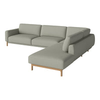 Light gray sectional sofa with clean lines and a minimalist design, featuring a soft fabric texture and wooden legs.
