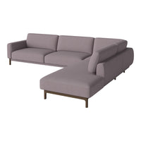 Light purple velvet sofa with a modern design and clean lines, featuring a chaise lounge and minimalist brown legs.