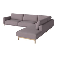 Modern sectional sofa in soft lavender fabric with clean lines and natural wood legs. Elegant and minimalist design.