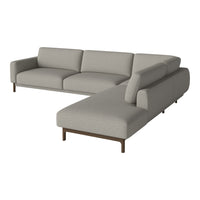 Light gray sectional sofa with sleek lines and soft fabric, featuring a minimalist design and subtle textures.
