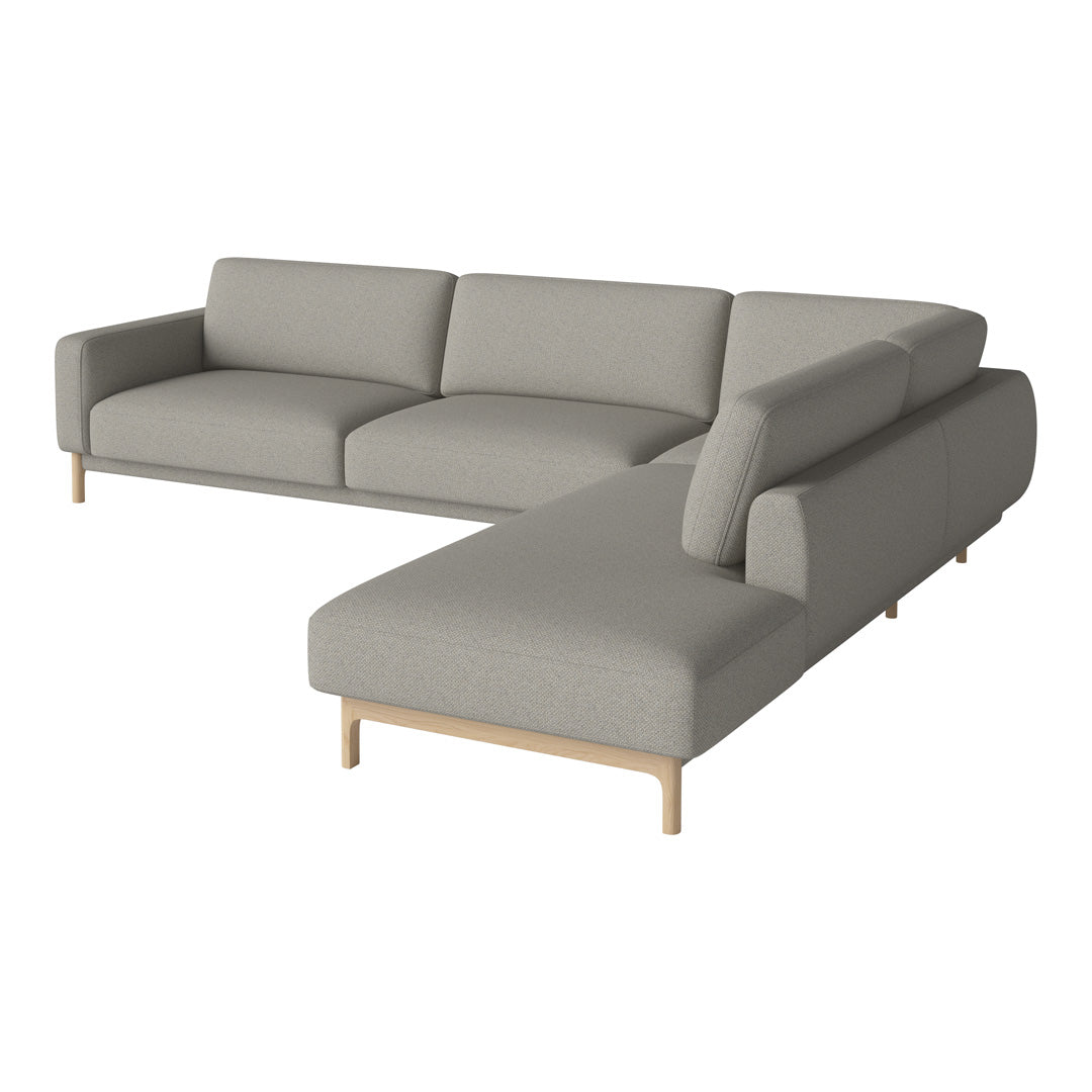 Modern L-shaped sofa in a soft gray fabric with smooth edges and light wooden legs, perfect for contemporary living spaces.