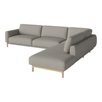 Modern L-shaped sofa in a soft gray fabric with smooth edges and light wooden legs, perfect for contemporary living spaces.