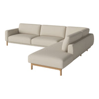 Beige sectional sofa with clean lines and soft upholstery, featuring a light wood base for a modern touch.