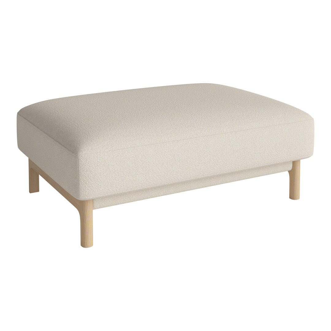 Cream-colored ottoman with a sleek, minimalist design and light wood legs. Versatile and modern for any space.