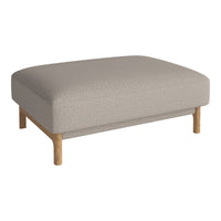 Light beige upholstered ottoman with subtle texture and natural wood legs, perfect for modern decor.