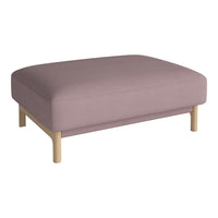 Light pink upholstered ottoman with a smooth, solid fabric and natural wood legs. Stylish and modern home accent.