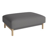 Gray upholstered ottoman with a smooth texture and natural wood legs, perfect for modern decor.