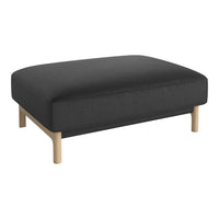 Black upholstered ottoman with a minimalist design and light wooden legs. Ideal for modern living spaces.
