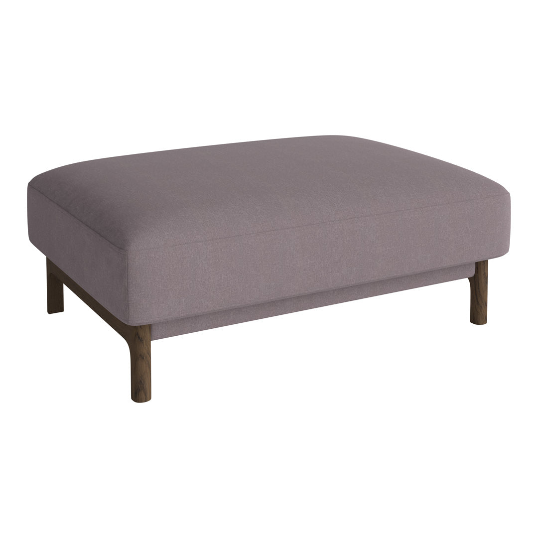 Light lavender ottoman with a smooth texture and dark wooden legs, perfect for modern decor.