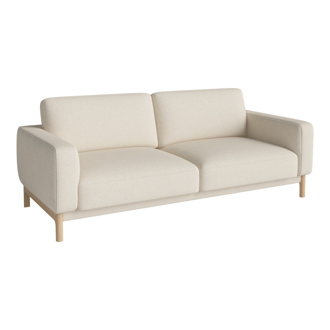 Cream-colored sofa with a minimalist design and soft fabric, featuring a light wood frame and clean lines.