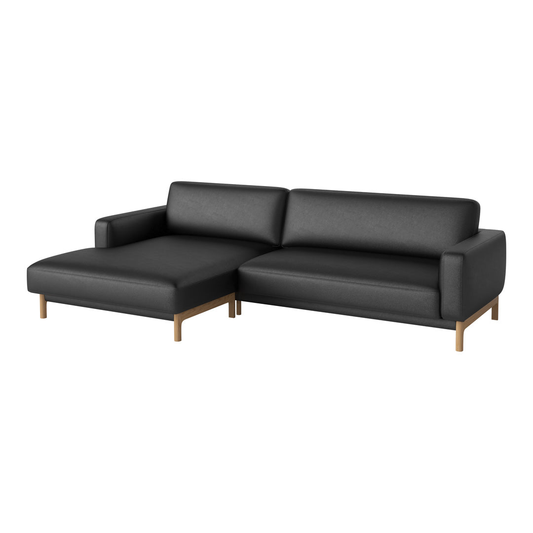 Modern black leather sectional sofa with sleek wood legs and minimalist design. Perfect for contemporary living spaces.