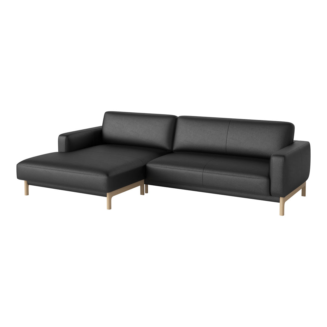 Black leather sectional sofa with a sleek design and wooden legs, featuring a modern and minimalist aesthetic.
