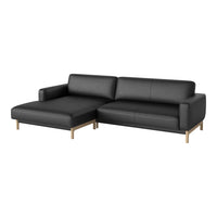 Black leather sectional sofa with a sleek design and wooden legs, featuring a modern and minimalist aesthetic.
