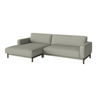 Light gray sectional sofa with smooth, minimalist design and dark wooden legs. Ideal for modern living spaces.