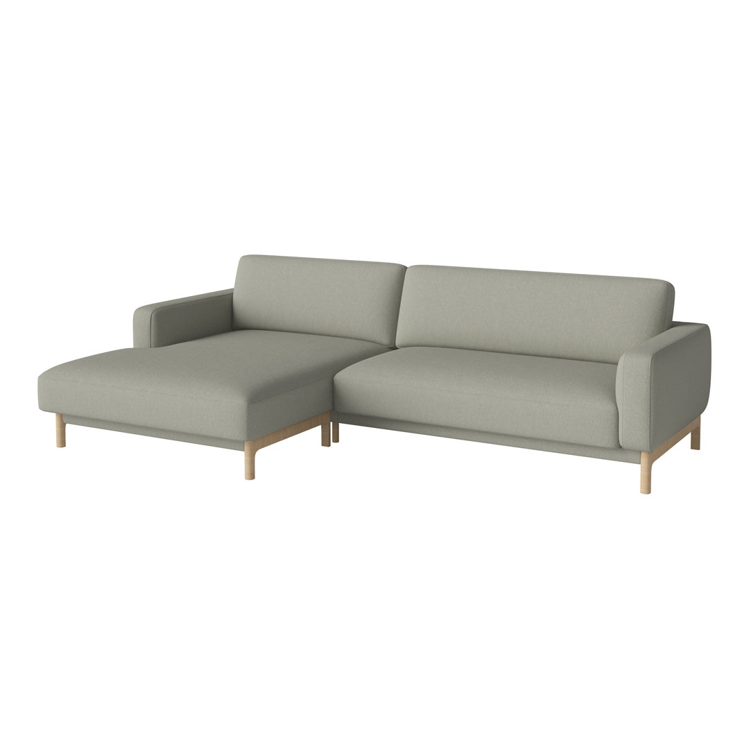 Light grey sectional sofa with clean lines and a minimalist design, complemented by natural wood legs.
