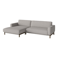 Light gray sectional sofa with a modern design, featuring smooth upholstery and minimalist wooden legs.