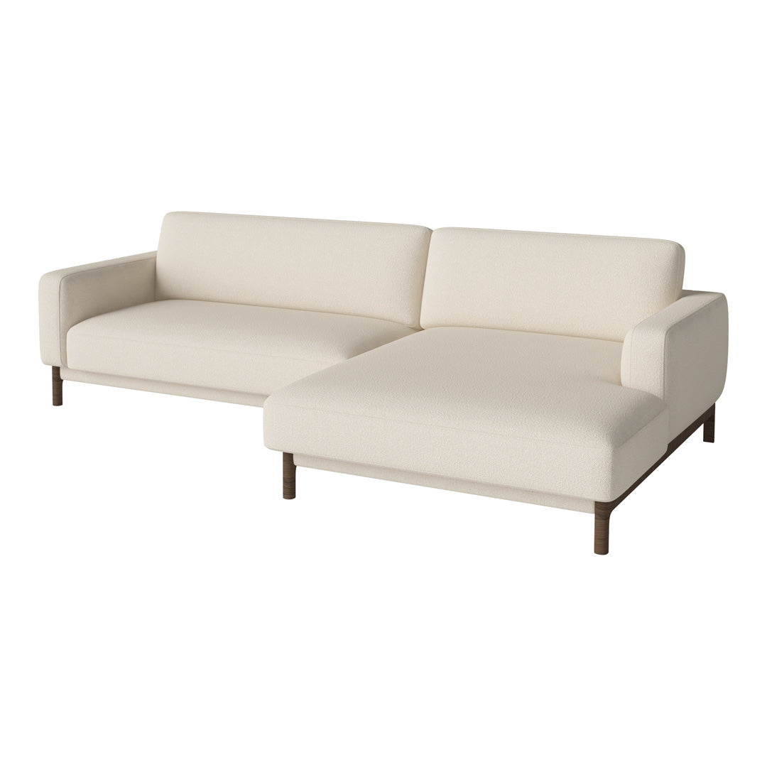 Cream-colored sectional sofa with a modern design and clean lines, featuring smooth fabric and wooden legs.