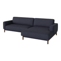 Navy blue fabric sectional sofa with clean lines and subtle texture, featuring dark wooden legs for a modern look.