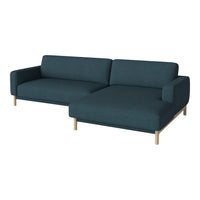 Teal upholstered sofa with a modern design, featuring a solid pattern and light wood legs.