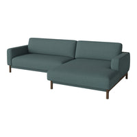Teal modern sofa with clean lines and a minimalist design, featuring a soft, textured fabric and wooden legs.