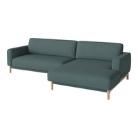 Teal fabric sectional sofa with a minimalist design and light wooden legs. Perfect for modern living spaces.