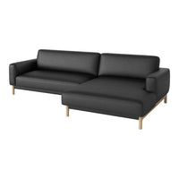 Contemporary black couch with sleek lines and wooden legs, perfect for modern living spaces.