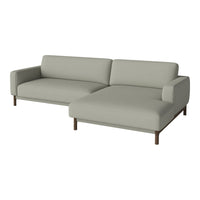 Light gray sectional sofa with clean lines and minimalist design, featuring smooth upholstery and wooden legs.
