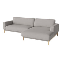 Light gray fabric sectional sofa with a minimalist design and natural wood legs. Smooth, modern upholstery.