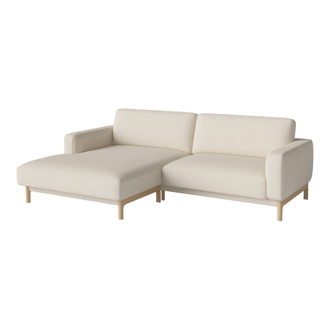 Beige fabric sectional sofa with clean lines and light wood legs, offering a modern, minimalist design.