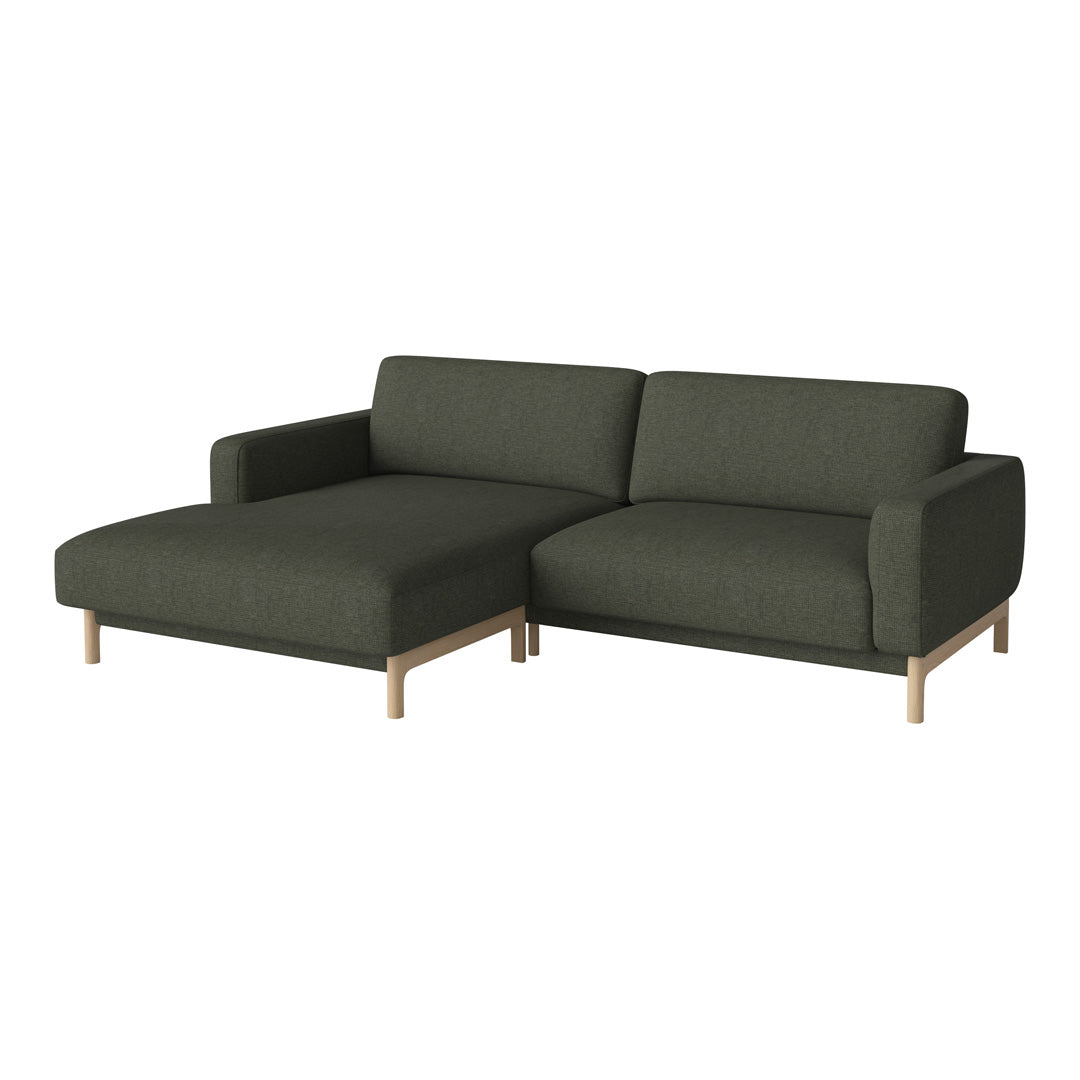 Dark green sectional sofa with a smooth fabric texture and light wood legs. Modern, minimalistic design for stylish interiors.