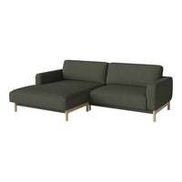 Dark green sectional sofa with a smooth fabric texture and light wood legs. Modern, minimalistic design for stylish interiors.