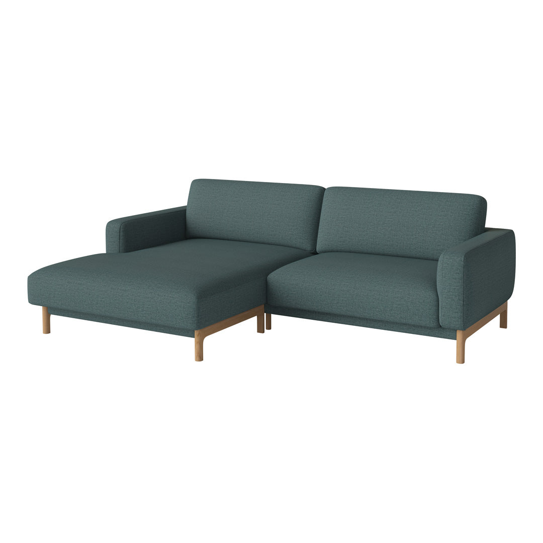 Stylish dark teal sectional sofa with sleek wood legs, featuring a modern, minimalist design. Perfect for contemporary decor.