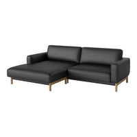 Black sectional sofa with clean lines and a minimalist design, complemented by warm wooden legs.