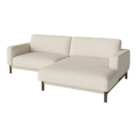 Cream-colored sectional sofa with a minimalist design and smooth fabric finish, featuring dark wooden legs.