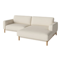 Cream-colored sectional sofa with a minimalist design and wooden legs, perfect for modern decor.