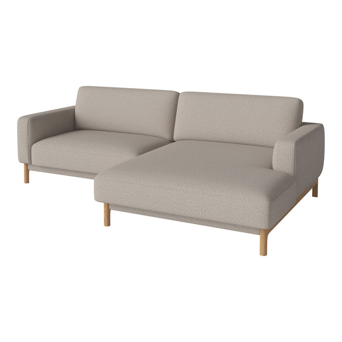 Light beige sectional sofa with a minimalist design and wooden legs, featuring clean lines and no pattern.