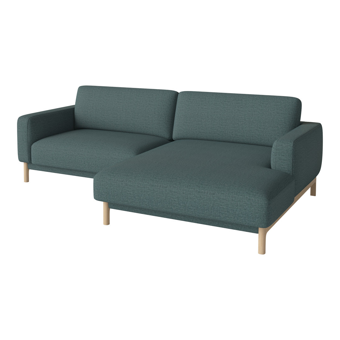 Teal green fabric sofa with a modern design and light wooden legs, featuring a solid, textured pattern.