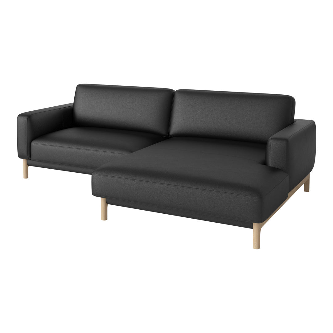 Black fabric sectional sofa with clean lines and warm wooden legs, creating a modern and minimalist aesthetic.