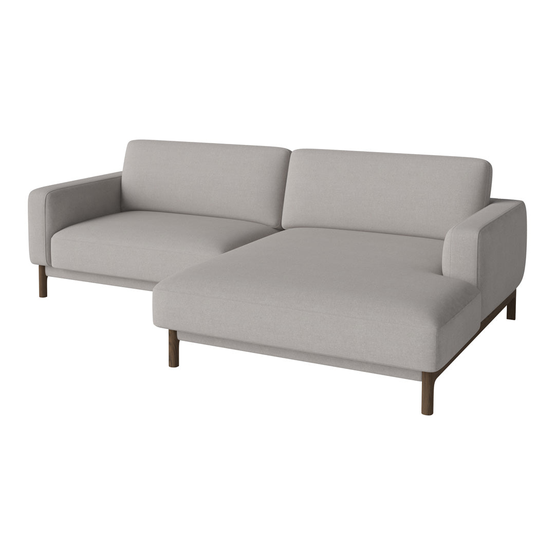 Light grey sectional sofa with a minimalist design and smooth fabric texture, complemented by wooden legs.