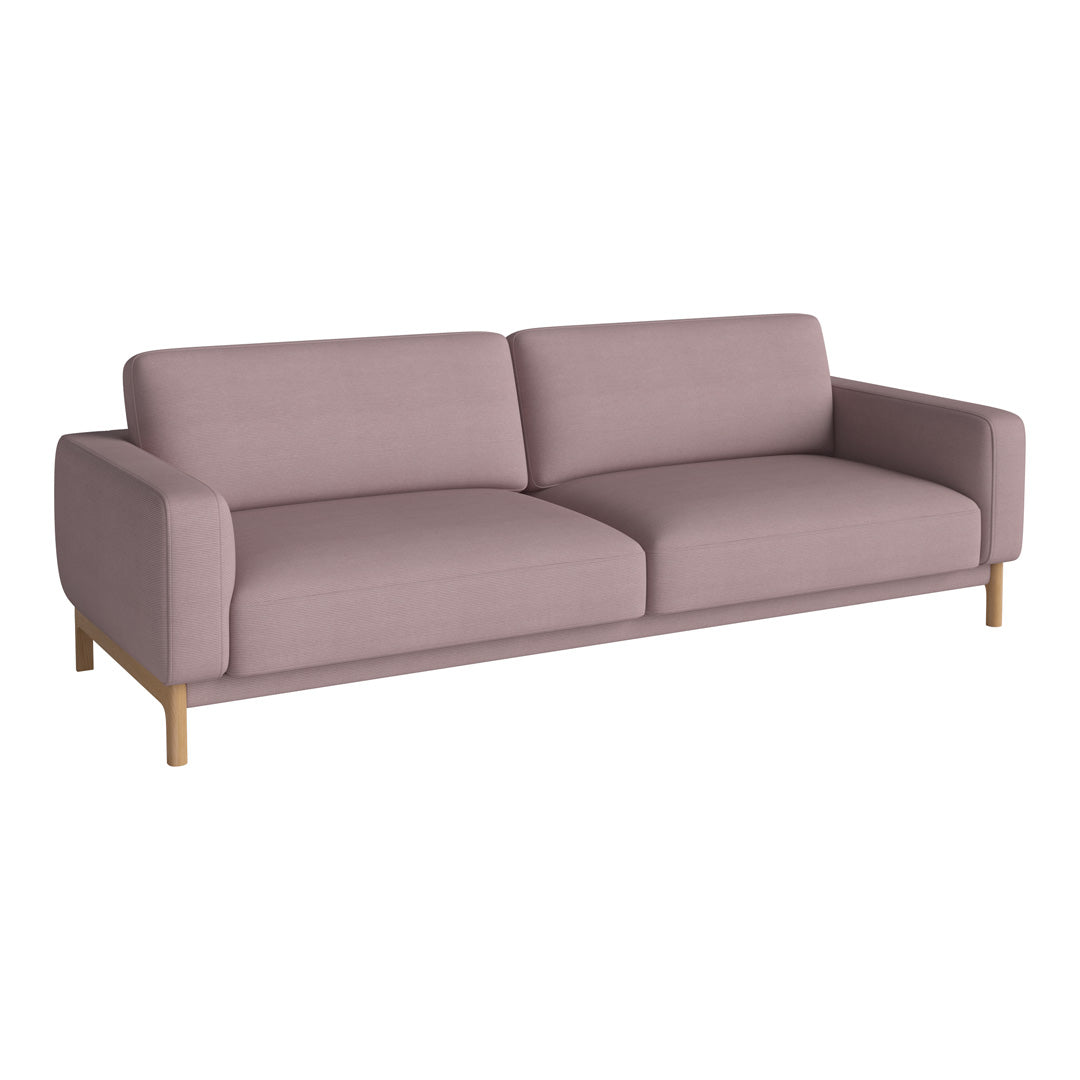 Soft pink fabric sofa with clean lines and minimalistic design, featuring light wooden legs for an elegant touch.