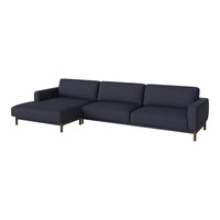 Navy blue sectional sofa with a sleek, modern design and clean lines, featuring solid color upholstery and wooden legs.