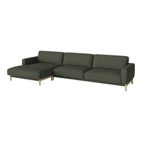 Modern dark green sectional sofa with clean lines and neutral wood legs. Perfect for stylish living spaces.