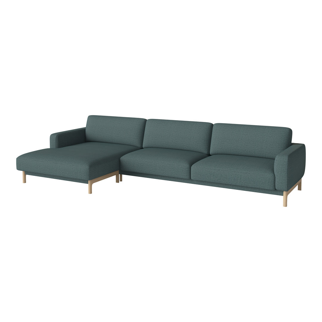 Chic teal sectional sofa with a minimalist design and smooth fabric, complemented by sleek wooden legs.