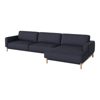Navy blue sectional sofa with a minimalist design and light wooden legs, featuring a solid color fabric upholstery.