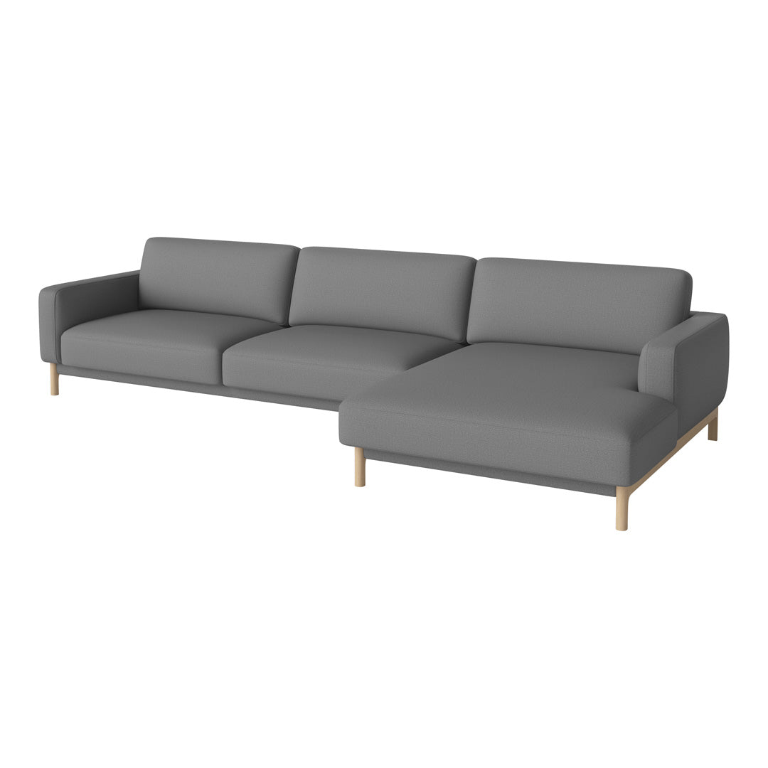Gray sectional sofa with a minimalist design and light wooden legs. Soft, solid color upholstery for modern decor.