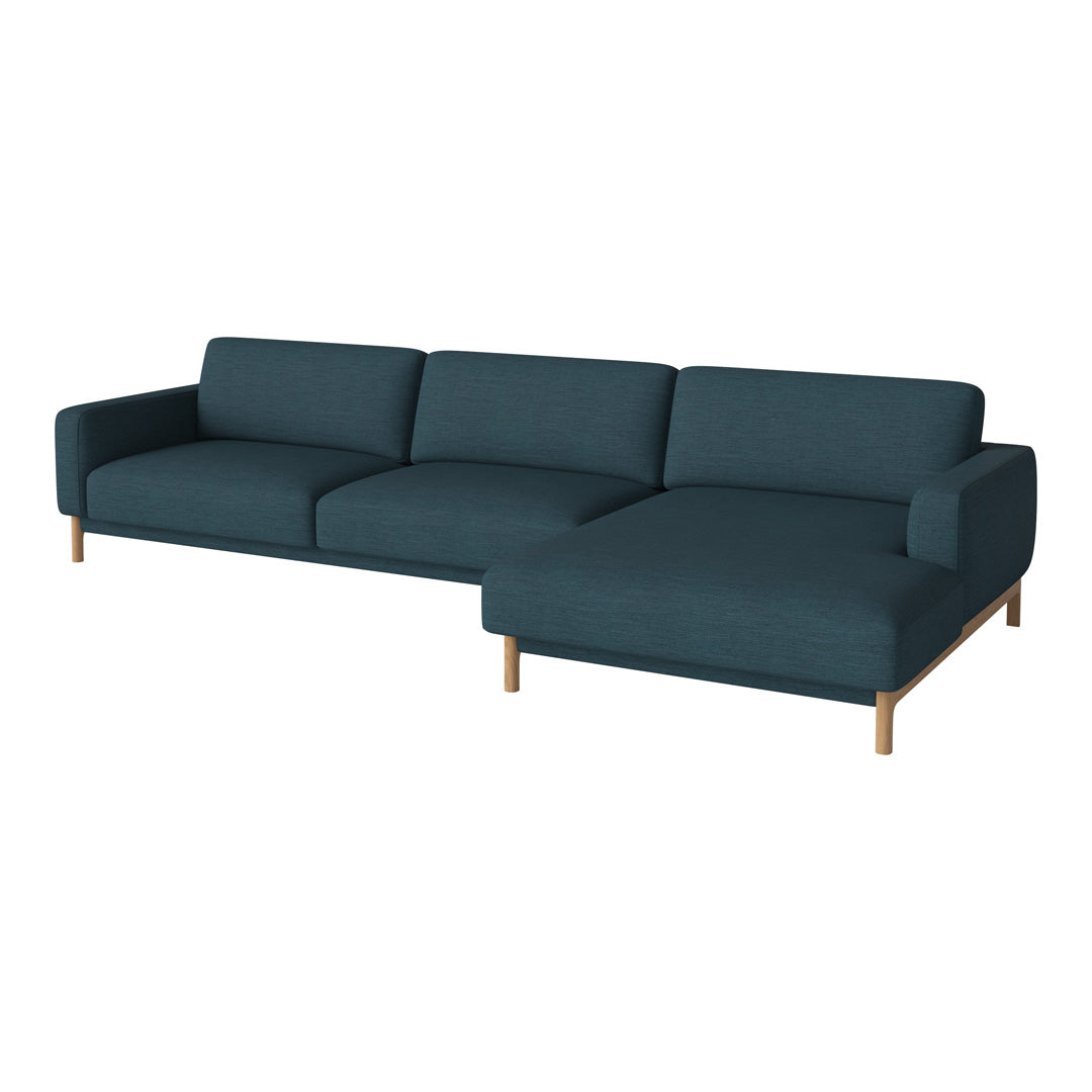 Teal fabric sectional sofa with clean lines and light wooden legs, featuring a minimalist design for modern interiors.